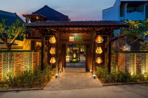 an entrance to a building with lights on it at DEMIN VILLA HỘI AN - POOL & BBQ Gaden in Hoi An +39 photos