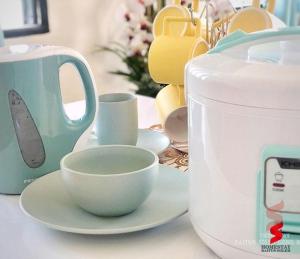 a table with a tea kettle and cups on it at Tasik Biru Homestay Kuala Terengganu in Marang