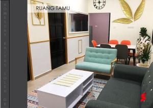 a living room with chairs and a table and a dining room at Tasik Biru Homestay Kuala Terengganu in Marang