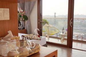 a living room with a view of a balcony at Cát Tường Hotel in Da Lat