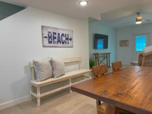 a dining room with a wooden table and a bench at B4 At Little Bay Landing in Rockport