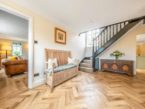 a living room with a staircase and a couch at Scarrow Beck House in Hanworth