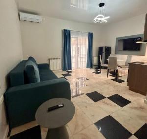 a living room with a green couch and a table at MaRailiS Port Apart Mangalia in Mangalia