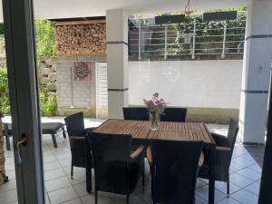 a wooden table and chairs with a vase of flowers on a patio at Ferienwohnung Auszeit in Boppard