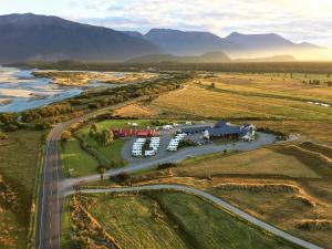 an aerial view of a road next to a river at Haast River Motels & Holiday Park in Haast