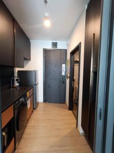 a kitchen with a hallway leading to a door at The Edge Central Pattaya Tops Luxury New Project in Ban Nong Chaeng