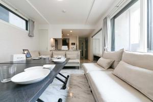a living room with a couch and a table at GaiarS8 in Sapporo