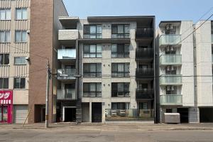 an apartment building with balconies on the side of it at GaiarS8 in Sapporo
