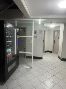 a empty room with a drink cooler in a building at Darwin City Escapes - 1 bedroom unit in Darwin