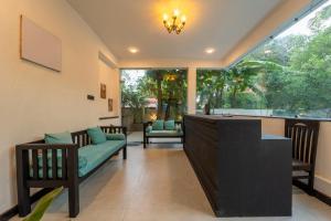 a living room with a couch and a table at Mysa by De Soul Santé in Morjim
