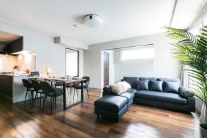 a living room with a couch and a table at Twinberry CHITOSE in Chitose