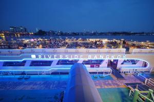 a view of a cruise ship at night at Riverside Bangkok Hotel in Bangkok