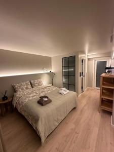 a bedroom with a large bed and a wooden floor at Newly Renovated Rom Bergen Fana in Bergen
