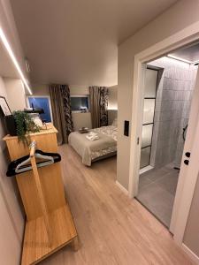 a bedroom with a bed and a walk in shower at Newly Renovated Rom Bergen Fana in Bergen