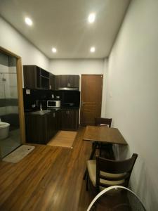 a kitchen with a table and chairs in a room at xh apartment in Danang