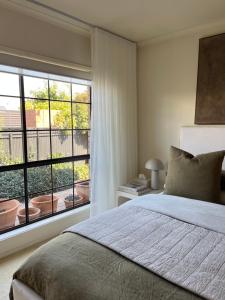 a bedroom with a bed and a large window at Interior Stylist's Country Unit in Nhill