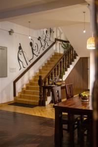 a staircase in a room with a table and a table sidx sidx at Oasis Bay - Arugam Bay in Arugam Bay