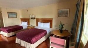 Postel nebo postele na pokoji v ubytování Grand Park Inn