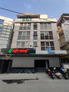 a building with two motorcycles parked in front of it at Treebo Terminus, Koramangala 5th Block in Bangalore