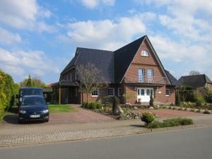 a car parked in front of a brick house at Hotel Heidetraum in Schneverdingen