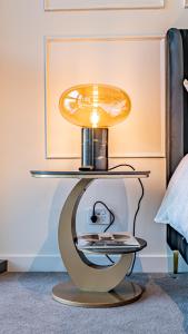 a table with a lamp on top of it at Riverside Reverie French Luxury at BNE Casino in Brisbane