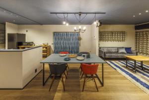a kitchen and living room with a table and chairs at villa-rizo緑ヶ丘 in Takayama