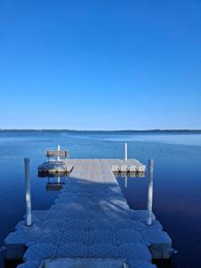 a dock in the middle of a body of water at Villa Lakeside in Osbyholm
