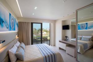 a hotel room with a bed and a mirror at Marinos Beach Hotel in Platanes +101 photos