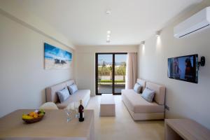 a living room with a couch and a table at Marinos Beach Hotel in Platanes