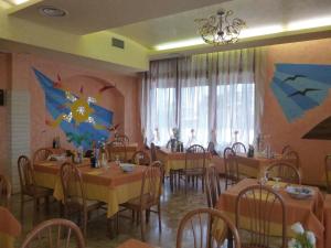ein Restaurant mit Tischen und Stühlen mit Leuten, die darauf sitzen in der Unterkunft Hotel Ristorante da Toni in Codevigo