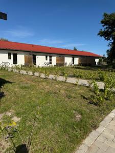 a building with a garden in front of it at Bøtø strand ferielejlighed 1 in Marielyst