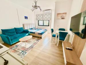 a living room with a blue couch and a table at Besmir's in Golem