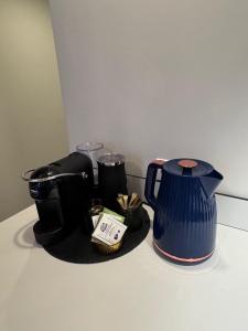 a coffee maker and a tea kettle on a counter at Albatross Loft in Ķesterciems