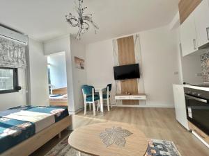 a bedroom with a bed and a table in a room at Besmir's in Golem