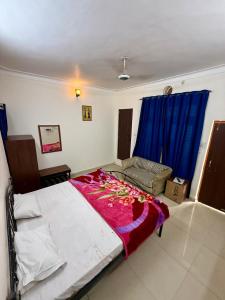 a bedroom with a large bed with flowers on it at KRISHNAM GUEST HOUSE in Gwalior