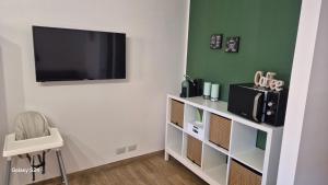 a living room with a tv on a wall at A casa di Ale in Mascali