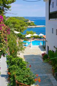 a view of a resort with a swimming pool and the ocean at Paradise Hotel in Patitiri