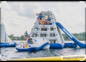 a group of people on a water slide in the water at Chimneys B&B in Ipswich