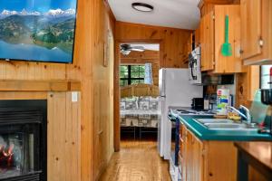 a kitchen with a stove and a refrigerator at Cozy Cabin, Fireplace, WiFi, Hot Tub, Views! in Sevierville