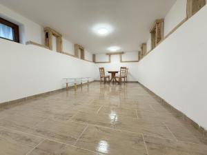 an empty room with a table and chairs in it at Farkas Vendégház Szabolcs in Szabolcs