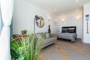 a living room with a couch and a mirror at La Maison Du Pêcheur in Cagnes-sur-Mer