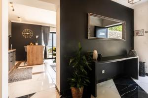a bathroom with a black wall and a mirror at Apartments Alba Chiara in Kastav