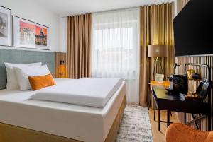 a hotel room with a bed and a desk at Aspire Palais Recklinghausen, Trademark Collection by Wyndham in Recklinghausen +61 photos
