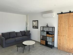 a living room with a couch and a table at villa de vacances in Cessenon