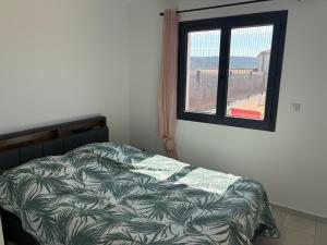 a bedroom with a bed and a window at villa de vacances in Cessenon