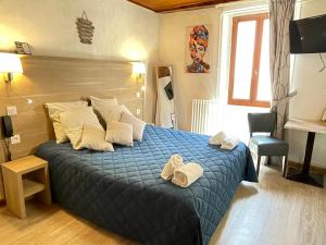 Postel nebo postele na pokoji v ubytování Hôtel Du Cheval Blanc Barcelonnette