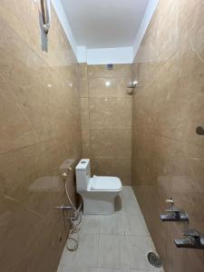 a bathroom with a toilet and a shower at Vasavi Palace Residency in Pennāttūr
