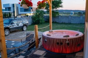 a hot tub on the porch of a house at MEM relax in Sebeş +5 photos