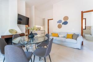 a living room with a glass table and a couch at Casa Il Nido, 250m to beach in Fort Village