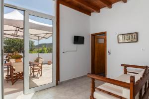 a room with a sliding glass door and a patio at Kondylis Cottage in Provatas